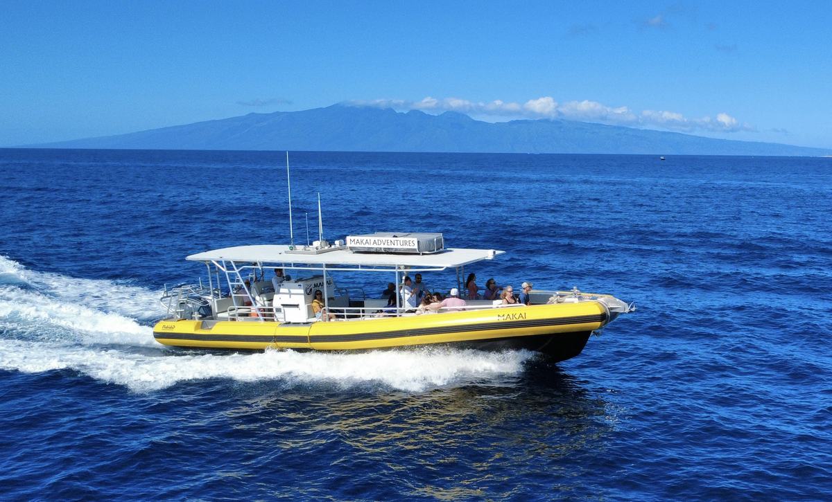 MAKAI, Makai Adventures’ yellow custom-built flagship, cruising past Lāna‘i