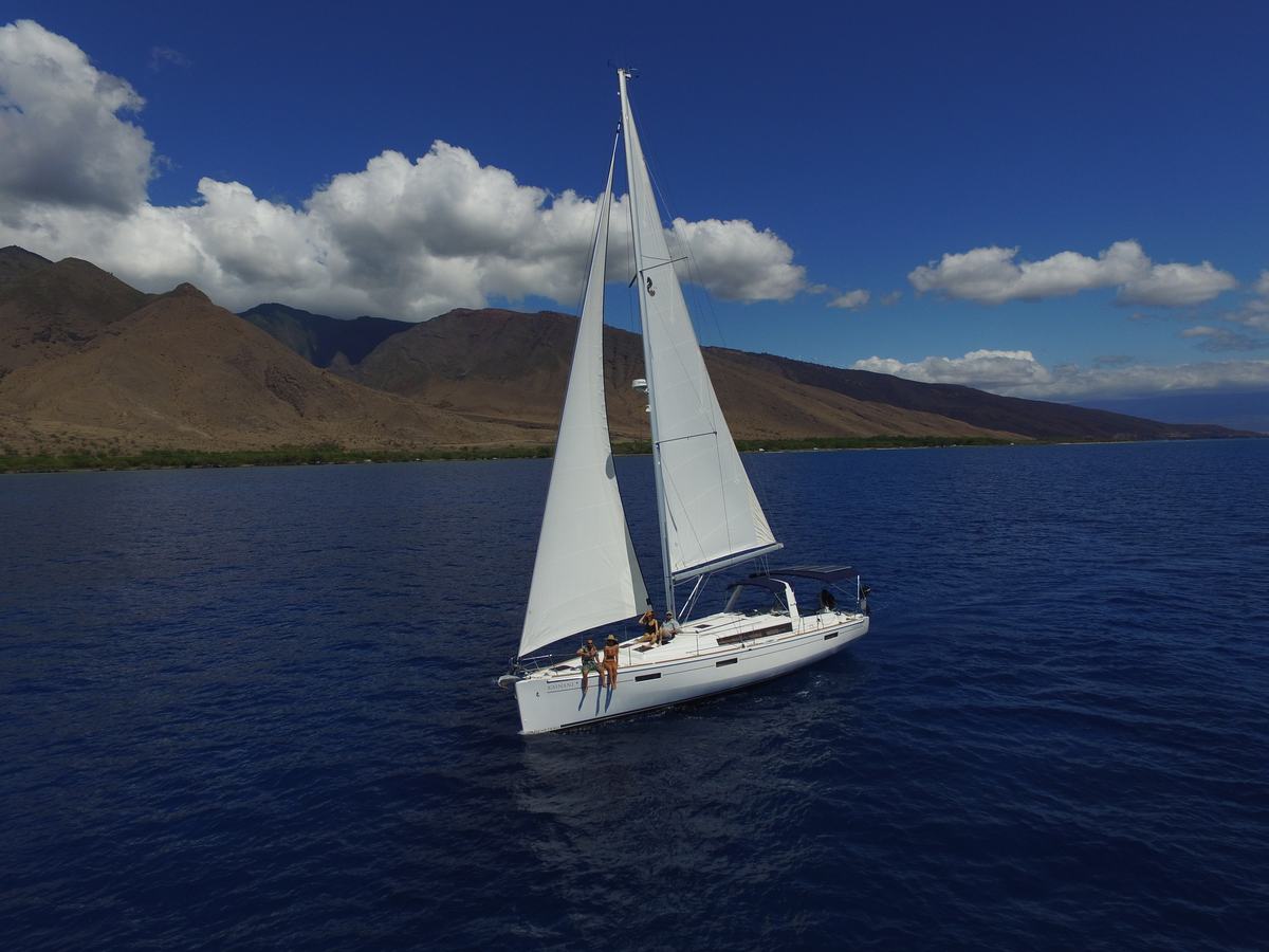 The sailboat Kainani under full sail off the West Maui mountains